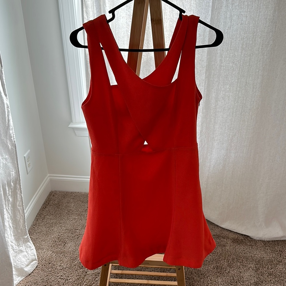 Bright red almost coral professional dress. Cut-outs on neck and stomach.